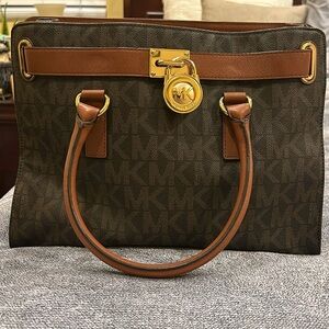 Michael Kors brown signature print leather handbag.
